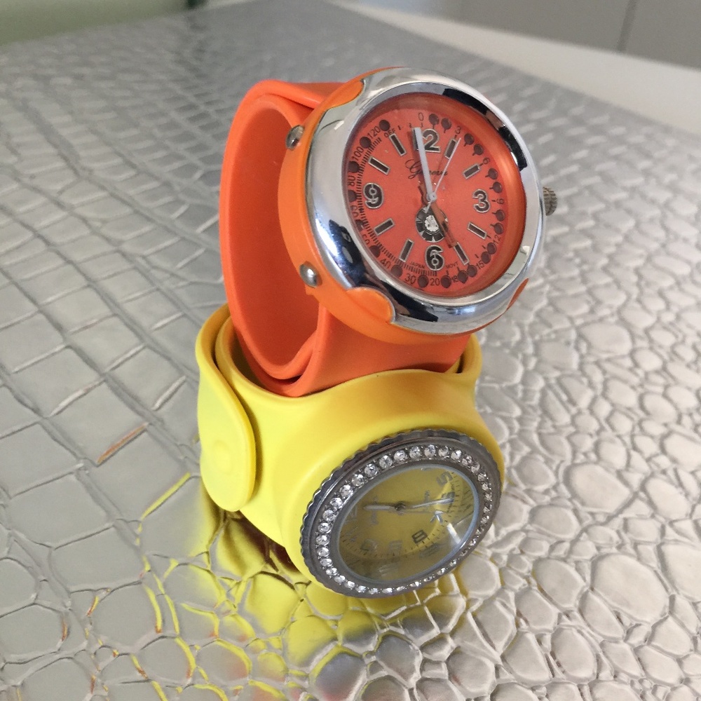 ONE YELLOW AND ONE ORANGE RUBBER WRAP AROUND WATCH FUN AND EASY TO WEAR NEED BAT